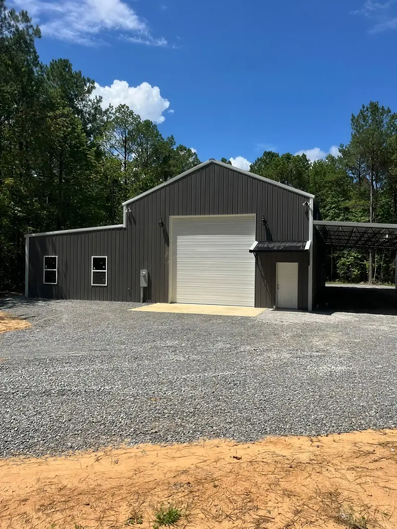 Dark metal garage with a tall overhead door