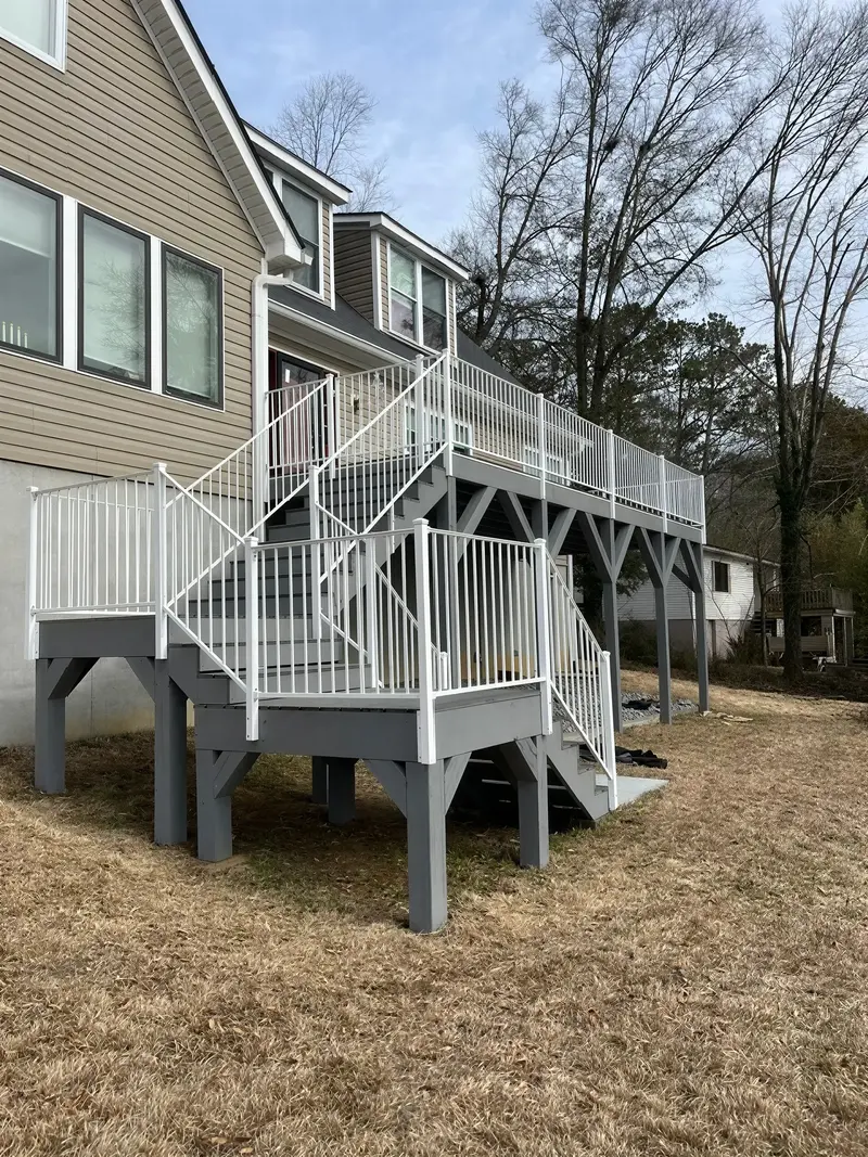 Side view of an elevated deck and white exterior staircase