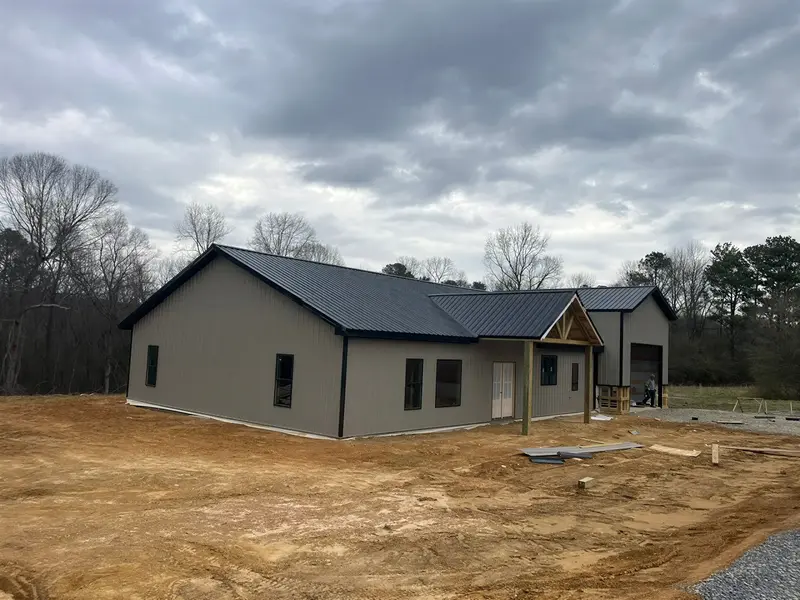 Residential building with a dark roof and covered front porch